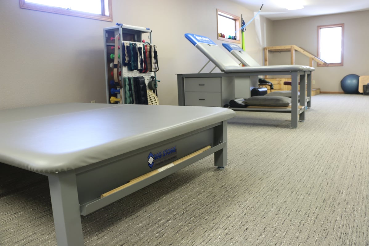 Aluma Elite Basic Treatment Tables and Aluma Elite Mat Table with branding